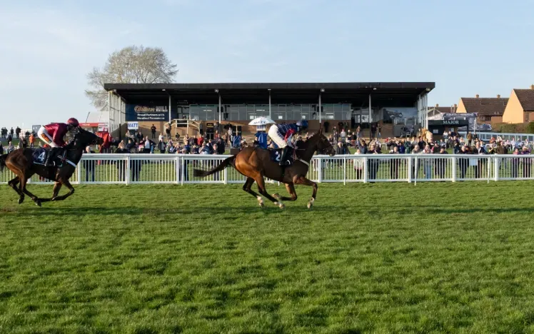 Horses racing past the grandstand on the horse track at Hereford