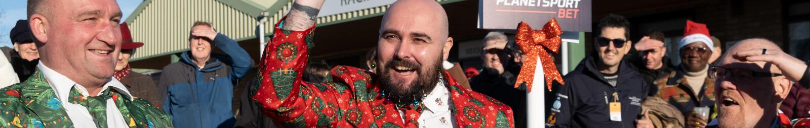 A group of gents in festive suits celebrate in the sunshine at Hereford Races