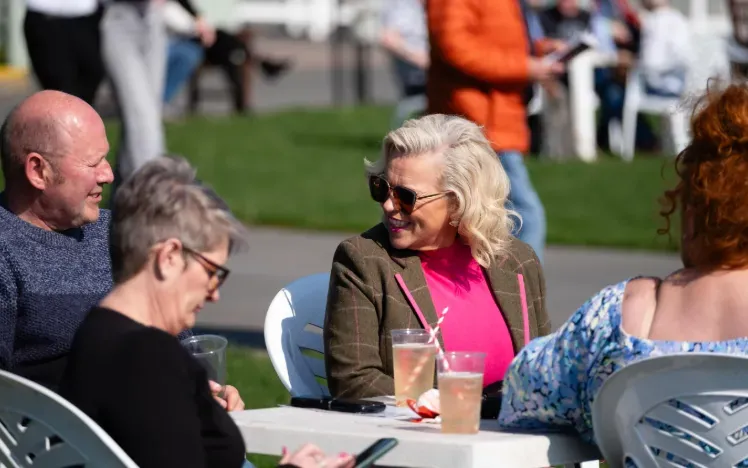 Racegoers at Hereford enjoy a relax in the sunshine before the racing