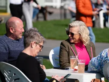 Racegoers at Hereford enjoy a relax in the sunshine before the racing