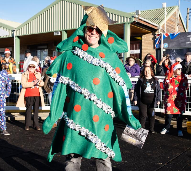 A man dressed as a Christmas tree at a race day at Hereford