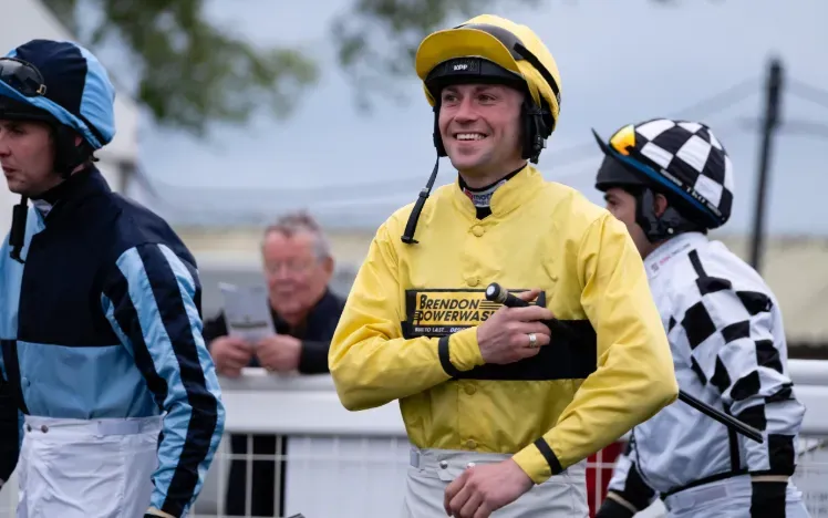 Several jockeys preparing for a race at Hereford.