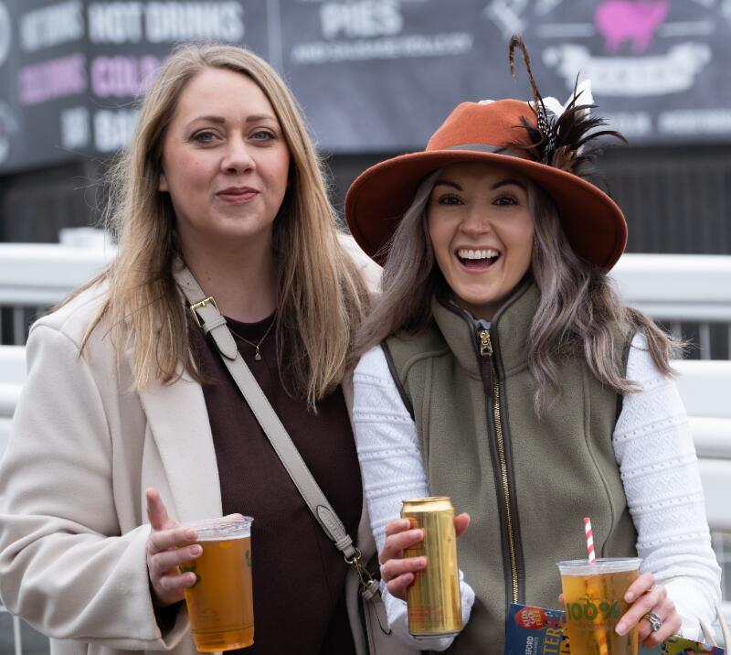 Two race goers holding drinks at Hereford Races