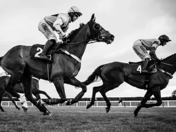 A black and white image of horses racing at Hereford racecourse