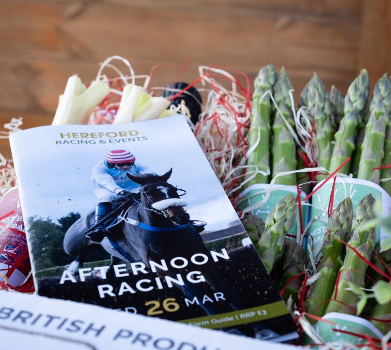 A close up of a racecard for Hereford races on top of a crate of fresh produce
