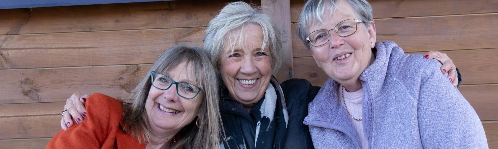 Three ladies posing for a photo at Hereford Racecourse